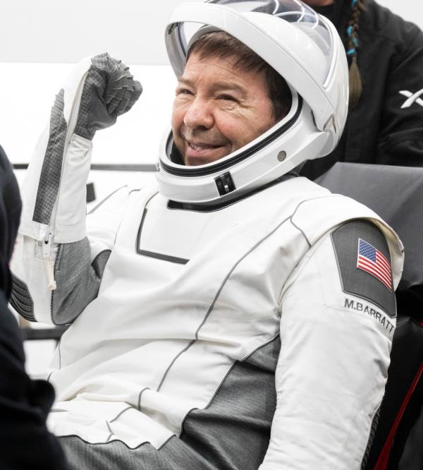 This photo shows NASA astro<em></em>naut Michael Barratt being helped out of the SpaceX Dragon Endeavour spacecraft o<em></em>nboard the SpaceX recovery ship.