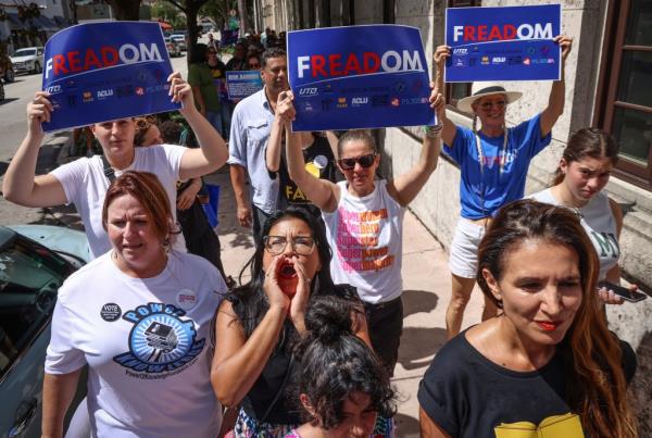 Karla Hernandez-Mats, president of United Teachers of Dade, center, leads in chanting slogans against book banning as marchers arrive at Books and Books in hope of bringing awareness to Florida's book banning, on Sunday, Oct. 1, 2023.