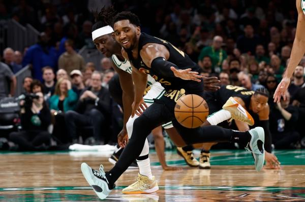 Do<em></em>novan Mitchell, who scored 33 points, battles for a loose ball with Jrue Holiday during the second quarter of the Celtics' win.