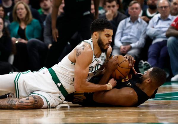 Jayson Tatum, who scored 18 points, battles Tristan Thompson for a loose ball during the Celtics' Game 1 win.