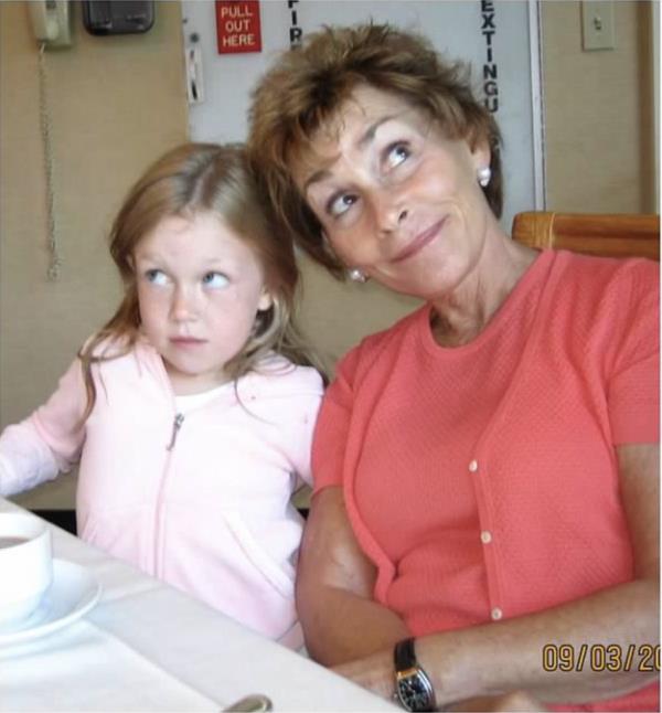 A young Sarah Rose wearing a pink Juicy Couture jumpsuit as a child next to hear grandmother Judge Judy Sheindlin. 