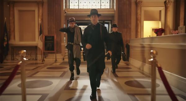 Men in hats walking in a building. 