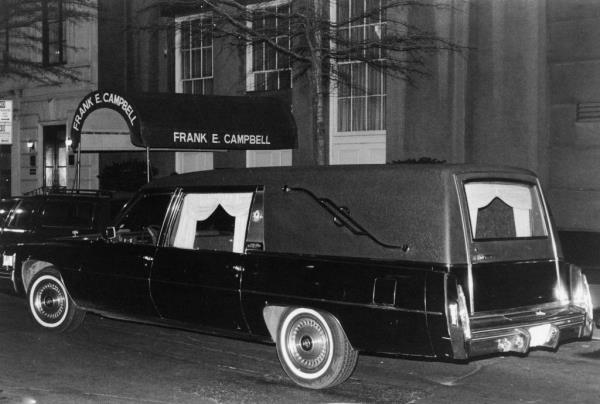 The hearse carrying John Lennon's body outside of Frank E.. Campbell