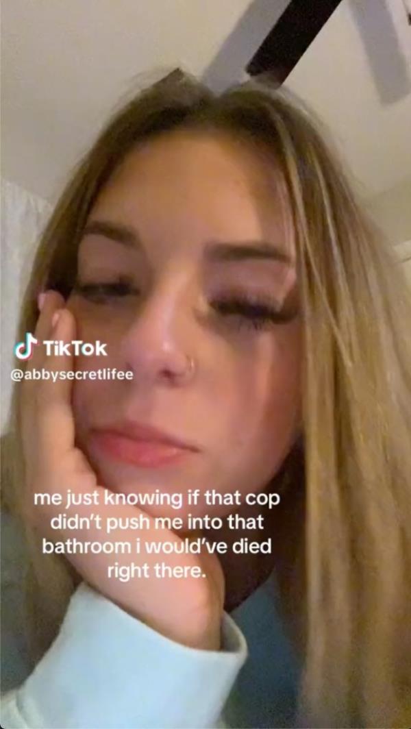 Screenshot of Abby Ayers' TikTok captio<em></em>ned “me just knowing if that cop didn’t push me into that bathroom i would’ve died right there.”