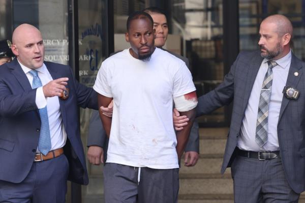 Tyshaun Watson is escorted out of the 13th Precinct.