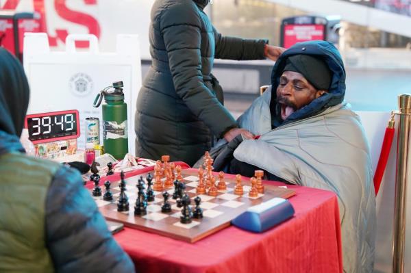 Nigerian chess grand master Tunde o<em></em>nakoya yawning during hour 39 of his attempt to break the Guinness world record for the lo<em></em>ngest chess marathon in Times Square, New York.