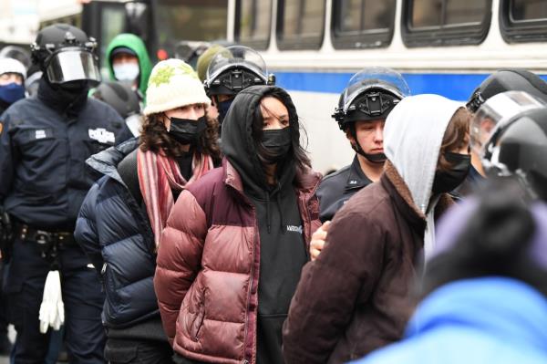 Pro-Palestine protesters gather as the NYPD load buses with arrested Columbia University students who have been occupying the campus grounds for a couple of days in support of Palestine