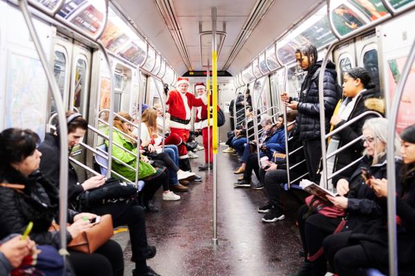 People dressed as Santa Claus ride the subway for the annual bar crawl SantaCon on December 14, 2019.