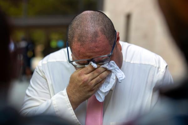 Paul Jamrowski, father of shooting victim Jordan Ancho<em></em>ndo and father in-law of victim Andre Anchondo, breaking down in tears while talking to the media outside of federal court on July 5, 2023.