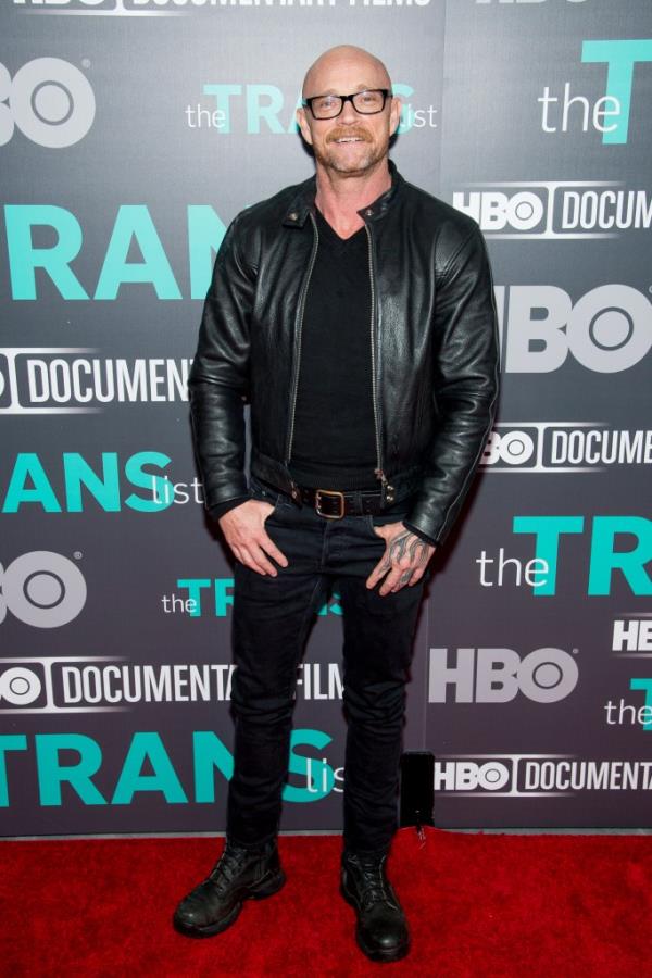 Buck Angel standing on a red carpet at an event.