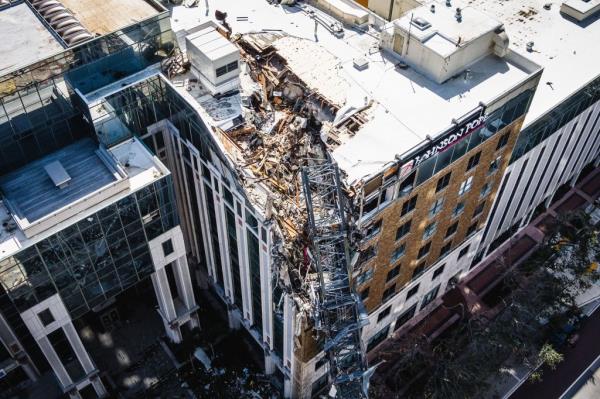 A collapsed crane against damaged building, aftermath of Hurricane Milton making landfall on Florida's Gulf Coast, October 10, 2024