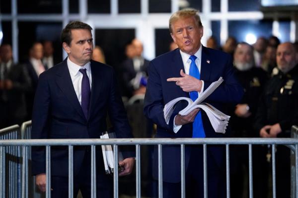Trump called the trial a hoax while showing off clippings of news articles a<em></em>bout it.