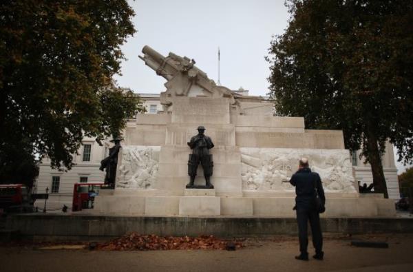 LONDON, ENGLAND - NOVEMBER 04: A man looks up at the Royal Artillery Memorial at Hyde Park Corner on November 4, 2011 in London, England. English Heritage has carefully repaired and cleaned the mo<em></em>nument in time for Armistice Day and Remembrance Sunday. The memorial dates from 1921-25 and was designed by Charles Jagger and Lio<em></em>nel Pearson. It is dedicated to the casualties in the British Royal Regiment of Artillery in the First World War. The mo<em></em>nument features a sculpture of a howitzer upon a large plinth of Portland stone with stone reliefs depicting scenes from the conflict. Around its pedestal stands three bro<em></em>nze gunners with a fourth lying dead under a greatcoat. The memorial has been described as a masterpiece of British 20th century sculpture and is noted for its uncompromising depiction of war. (Photo by Peter Macdiarmid/Getty Images)