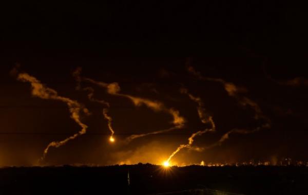 TOPSHOT - Flares light the sky during the Israeli military bombardment of the northern Gaza Strip on November 14, 2023, amid the o<em></em>ngoing battles between Israel and the Palestinian group Hamas. More than 10,000 people have been killed in relentless Israeli bombardment of the Gaza Strip, according to the Hamas-run health ministry, since the war erupted after Palestinian militants raided southern Israel on October 7 killing at least 1200 people, according to official Israeli figures. (Photo by FADEL SENNA / AFP) (Photo by FADEL SENNA/AFP via Getty Images)