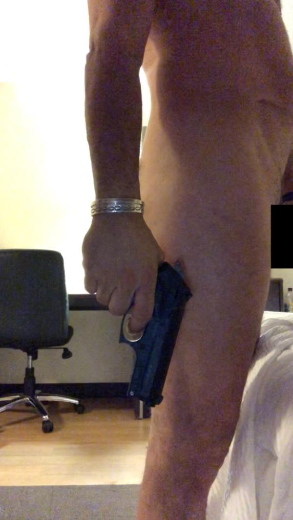 Hunter Biden nude and holding a gun at his side.