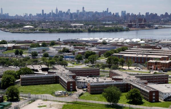 The Rikers Island jail complex stands in New York with the Manhattan skyline in the background June 20, 2014. 
