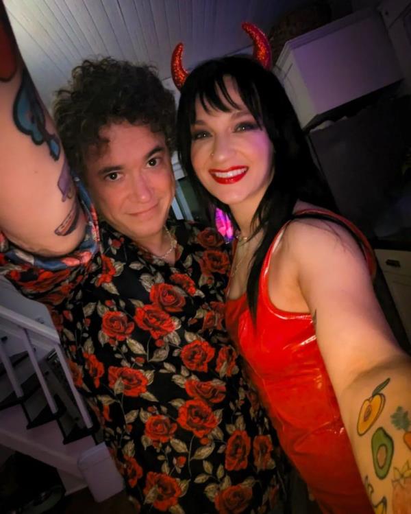 Chef Eric Rivera standing next to a woman in devil horns.