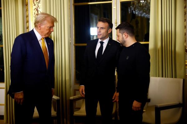 Macron and Trump attend a meeting at the Elysee Palace in Paris.