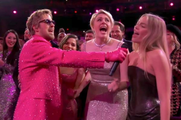 Margot Robbie sings along during the performance at the 96th Academy Awards.