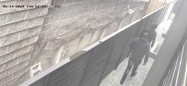 The intruder walks toward the home.
