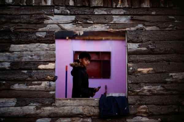 Venezuelan immigrant Javier Herrera looks out of a window, near the house wher<em></em>e 14 fellow Venezuelan immigrants died in a fire in an informal settlement, in Coronel, Chile Nov. 23.