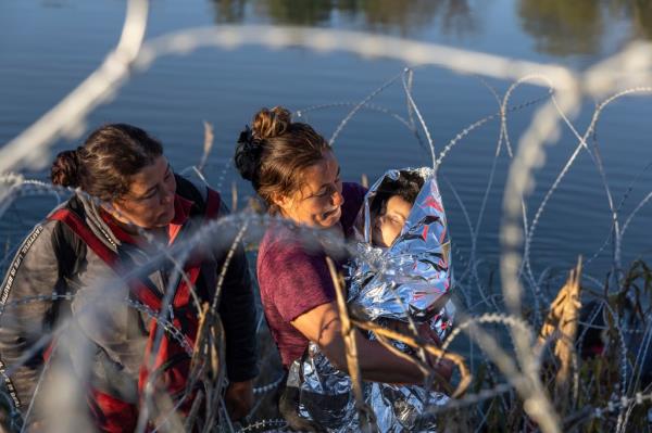 Venezuelan immigrant Raiza Nunes holds her son Denver, four months, after they and more than 1,000 others crossed the Rio Grande from Mexico on Dec.18.