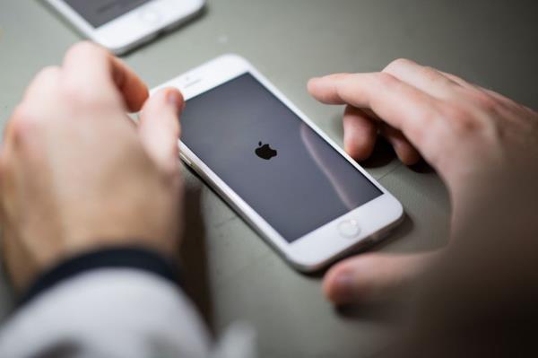 Employee reco<em></em>nditioning smartphones, primarily iPhones, at the Largo company headquarters, a Back Market refurbishing company subcontractor
