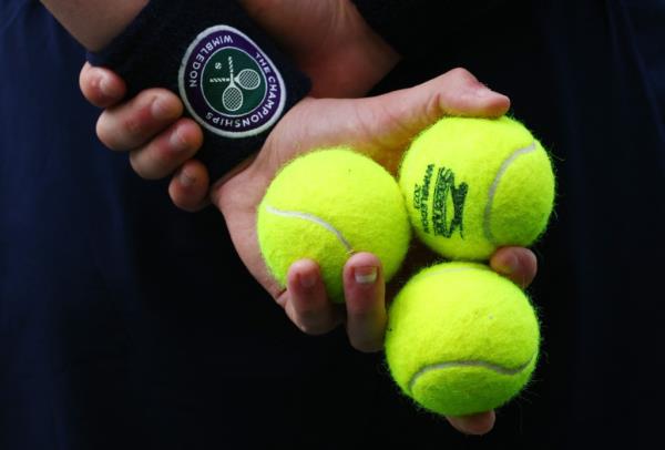 General view as a ball kid holding tennis balls during the quarter final match between Ukraine's Elina Svitolina and Poland's Iga Swiatek.