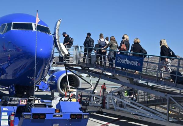 Passengers boarding a Southwest Airlines airplane at Hollywood Burbank Airport on October 10, 2021, amid numerous flight cancellations