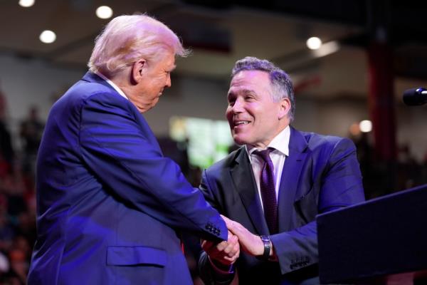 Former President Do<em></em>nald Trump shaking hands with Senate candidate Dave McCormick at a campaign event in Indiana University of Pennsylvania Ed Fry Arena