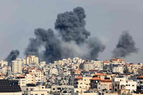 Smoke billows over Gaza City during an Israeli air strike on October 7