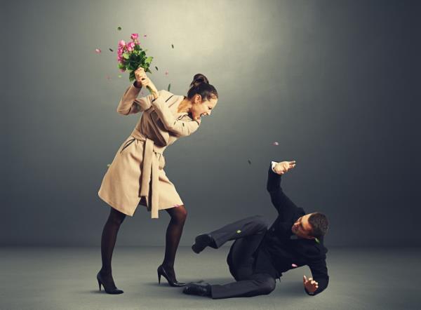 Woman beating up man on ground.