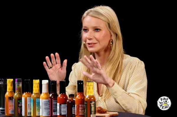 Gwyneth Paltrow in front of hot sauces. 