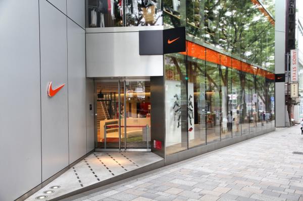 Shoppers visiting a Nike store with glass windows in Omotesando, Tokyo on May 9, 2012
