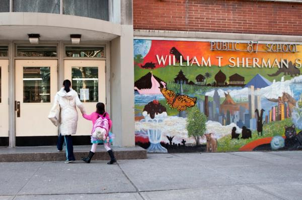 outside of PS 87 on the Upper West side, mom and daughter seen walking toward entrance.