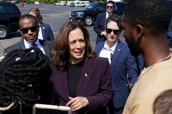 Kamala Harris speaks with supporters as she walks to board Marine Two to depart from the Soldier Field landing zone in Chicago, Illinois, August 23, 2024.