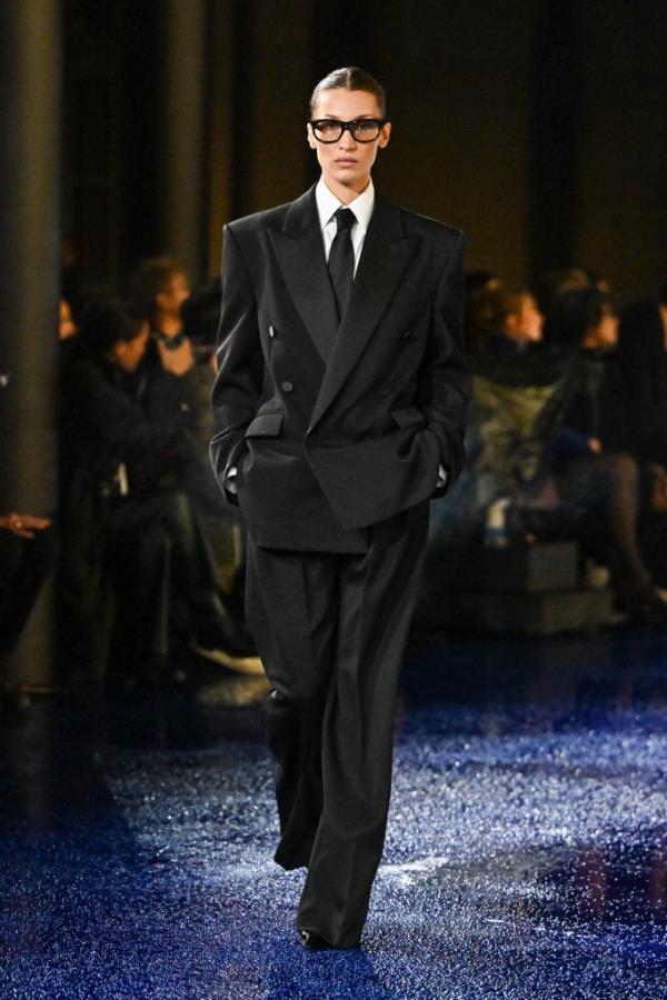 Bella Hadid, 28, in a necktie while walking in Saint Laurent Womenswear Spring-Summer 2025 show.  