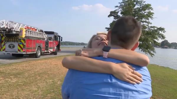 The newly engaged couple share a hug.