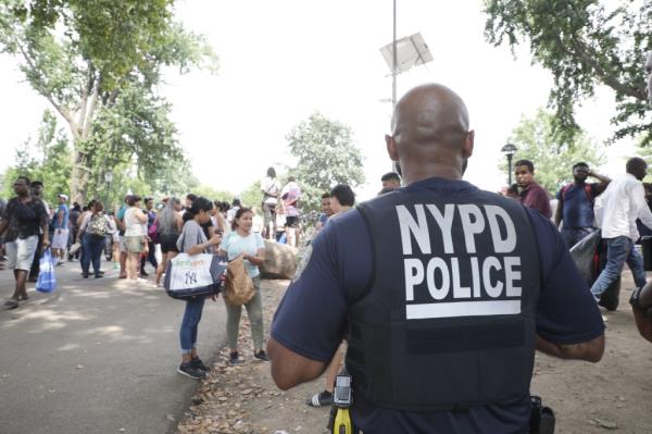 Cops patrol Randall's Island migrant shelter.