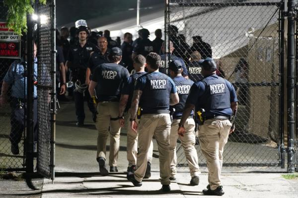 Police at Randall's Island migrant shelter.