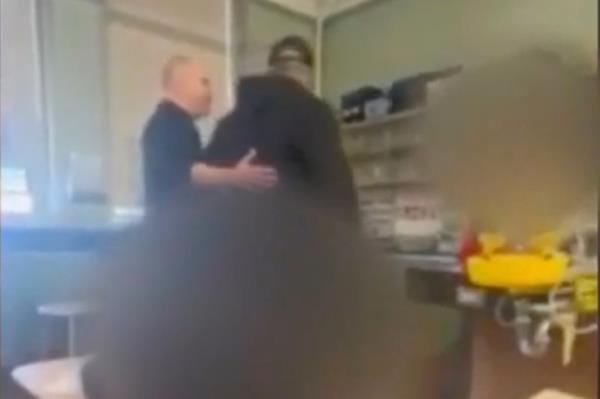 The adult can be seen trying to lead Thomas out of the classroom.