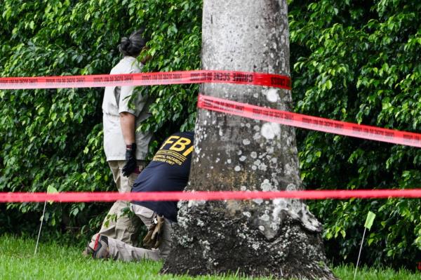 Members of FBI are seen at the crime scene outside the Trump Internatio<em></em>nal Golf Club in West Palm Beach.