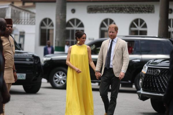 Prince Harry and Meghan, Duchess of Sussex, holding hands as they arrive at the State Governor House in Lagos, Nigeria for the Invictus Games anniversary celebrations.