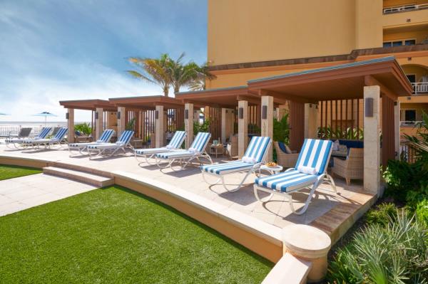 Beachfront Eau Palm Beach resort with pool and cabanas.