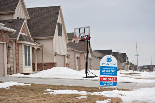 A for sale sign stands outside a new home in Bloomington, Illinois, U.S., on Tuesday, Feb. 15, 2011.