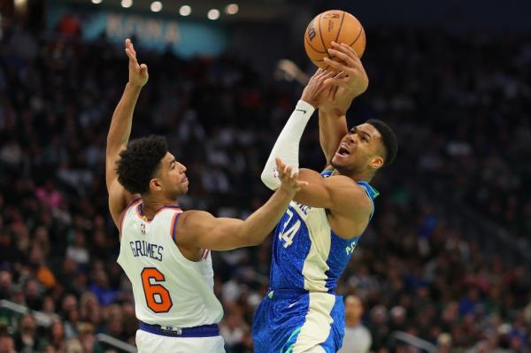 Giannis Antetokounmpo #34 of the Milwaukee Bucks is fouled by Quentin Grimes #6 of the New York Knicks during the first quarter of the NBA In-Season Tournament Quarterfinal at Fiserv Forum on December 05, 2023 in Milwaukee, Wisconsin.