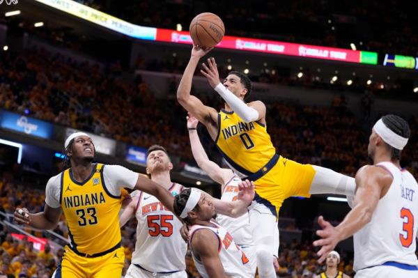 Pacers guard Tyrese Haliburton (0) is fouled by New York Knicks guard Miles McBride while driving to the basket