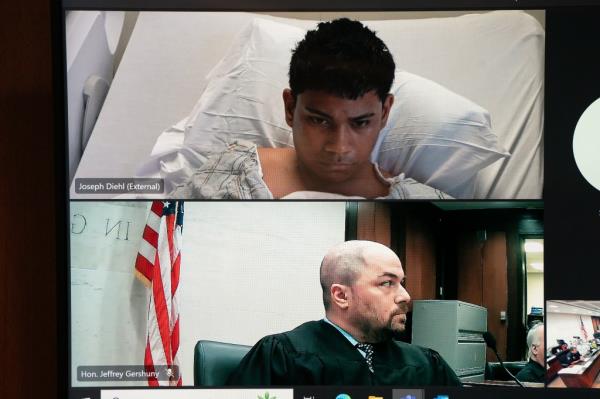 Suspected El Tren De Aragua member Bernardo Castro Mata, appearing from his hospital bedside