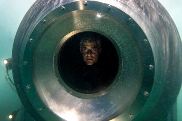 Stockton Rush peers out of the porthole on the Titan submersible while testing it in the Bahamas, May 2018.