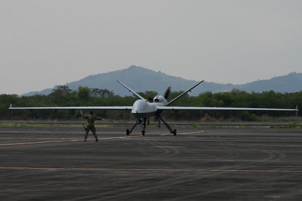 A US soldier guides the MQ-9 Reaper drone as it lands at Subic Bay Freeport Zone on April 23, 2023